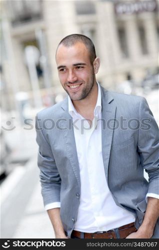 Cheerful young man walking in town