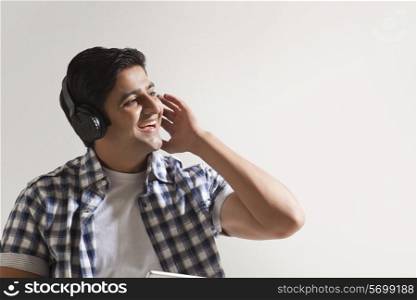 Cheerful young man wearing headphones