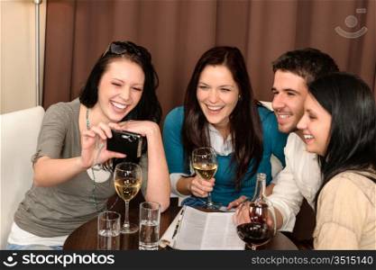 Cheerful young people enjoy drink after work at restaurant