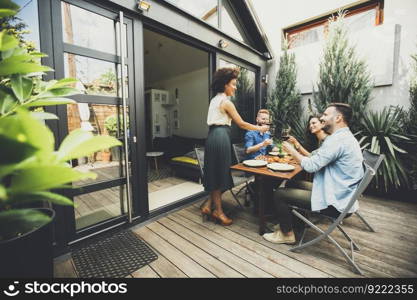 Cheerful young people have lunch in the courtyard and have a fun