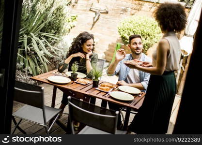 Cheerful young people have lunch in the courtyard and have a fun