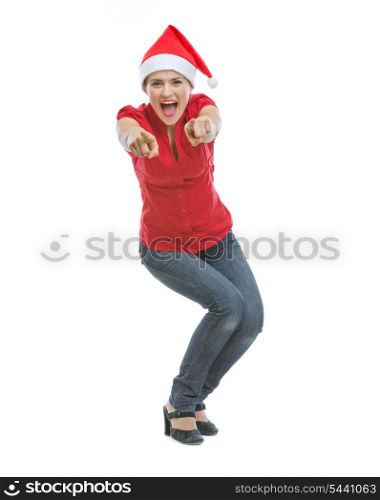 Cheerful young woman in Christmas hat pointing in camera