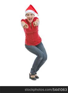 Cheerful young woman in Christmas hat pointing in camera