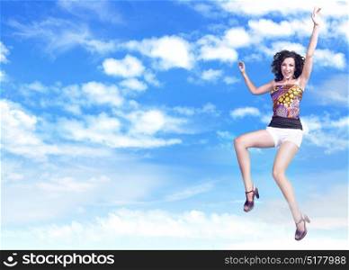 Cheerful young woman jumping up to the sky