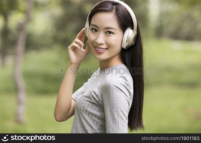 Cheerful young woman listening to music