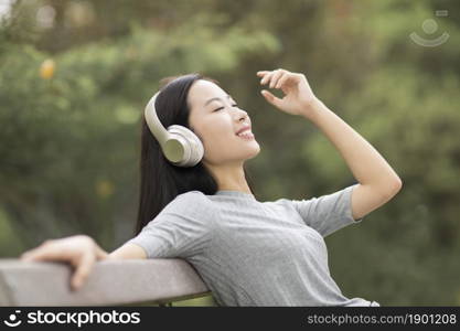 Cheerful young woman listening to music