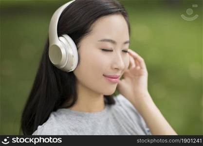 Cheerful young woman listening to music