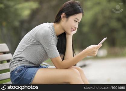 Cheerful young woman using her phone