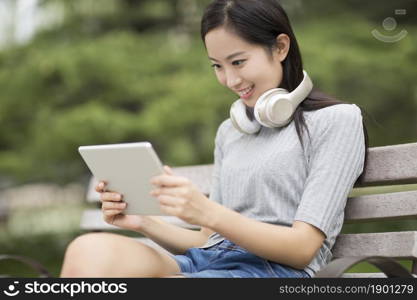 Cheerful young woman using her tablet computer