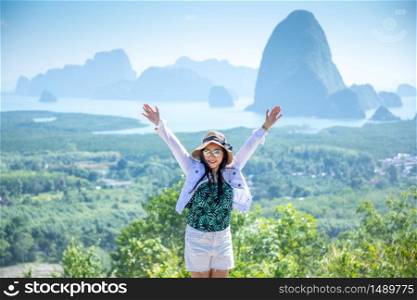 cheering woman hiker open arms at Phang Nga Bay from Samed Nang Chee, Thailand