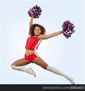 cheerleader girl jumping. Uniformed cheerleader jumps high in the air isolated on white.