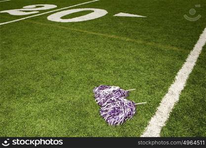 Cheerleading pom-poms on football field