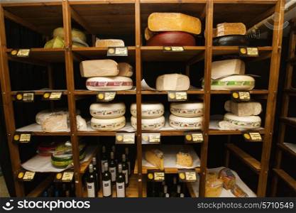 Cheese and alcoholic beverages on shelves at store