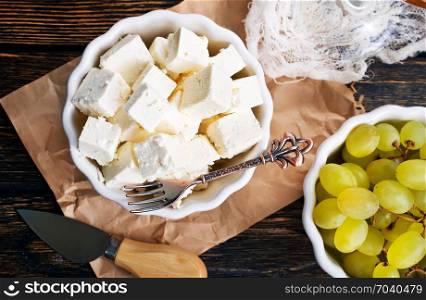cheese and white grape on a table