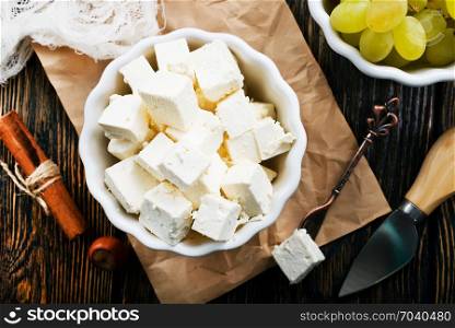 cheese and white grape on a table
