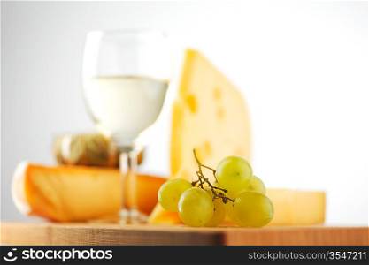 cheese and wine on a wooden table
