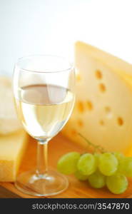 cheese and wine on a wooden table