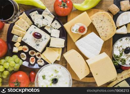 cheese blocks slices with tomatoes grapes green chili pepper table. High resolution photo. cheese blocks slices with tomatoes grapes green chili pepper table. High quality photo