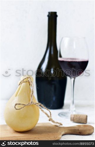 Cheese Caciocavallo and a glass of red wine. Cheese pear.. Cheese Caciocavallo and a glass of red wine. Cheese pear