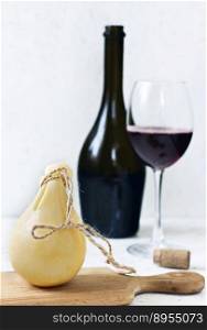 Cheese Caciocavallo and a glass of red wine. Cheese pear.. Cheese Caciocavallo and a glass of red wine. Cheese pear