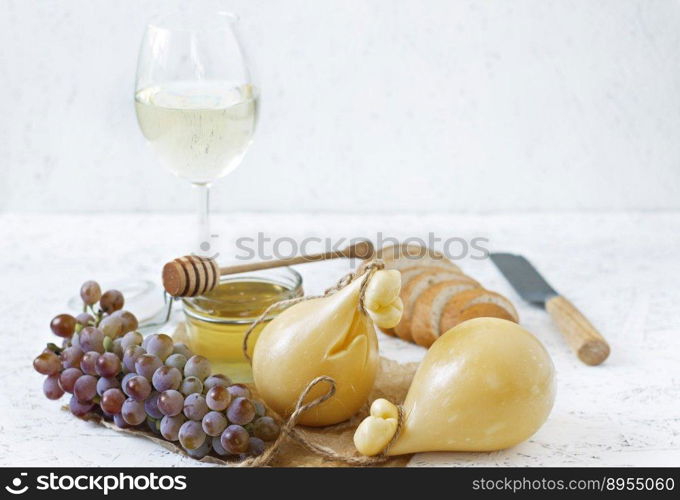 Cheese Caciocavallo wine, honey, bread on a white background. Cheese pear.. Cheese Caciocavallo wine, honey, bread on a white background. Cheese pear