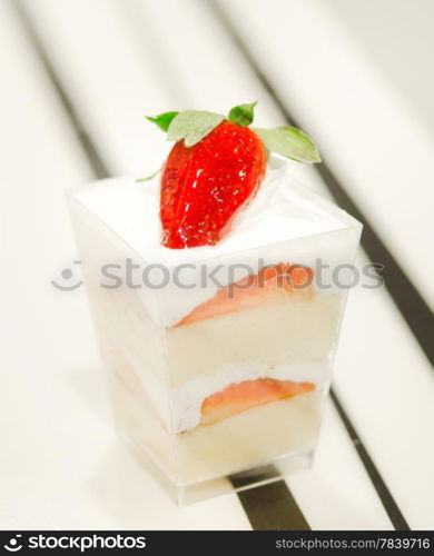 cheese cake with strawberries, decorated with fresh strawberries , served in a bowl with a small