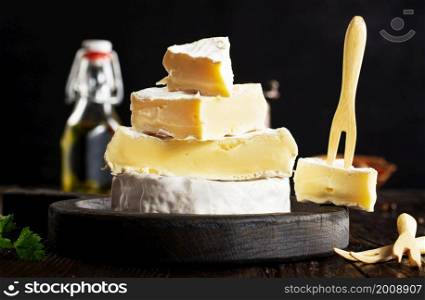 Cheese camambert on wooden board.