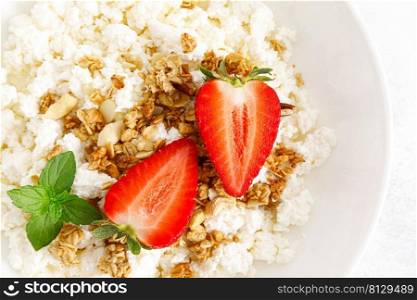 Cheese cottage, curd cheese with granola and fresh strawberry. Breakfast. Healthy food, diet. Top view