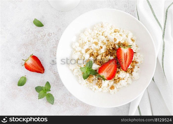 Cheese cottage, curd cheese with granola and fresh strawberry. Breakfast. Healthy food, diet. Top view