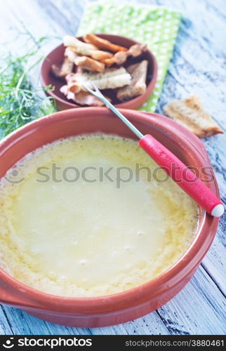 cheese fondue and dry bread on a table