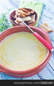 cheese fondue and dry bread on a table
