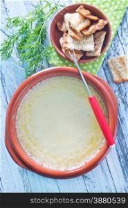 cheese fondue and dry bread on a table