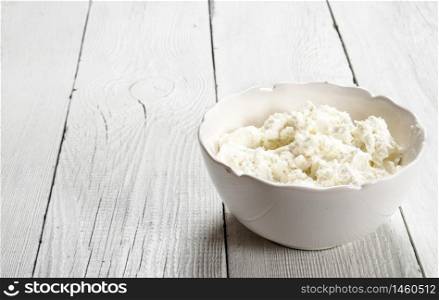 Cheese from fresh milk. On a white wooden background.. Cheese from fresh milk.