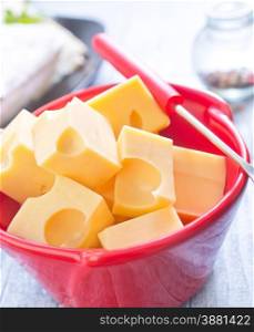 cheese in bowl and on a table