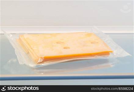 Cheese in opened fridge concept.. Cheese in opened fridge concept