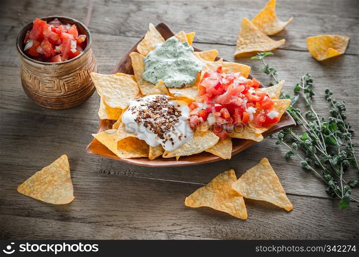 Cheese nachos with different types of sauce