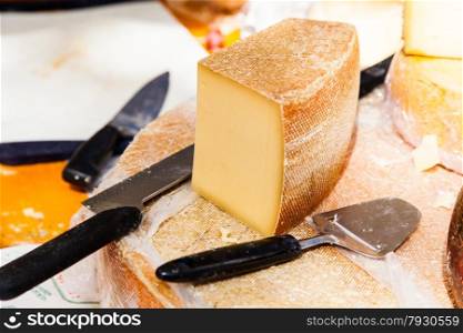 cheese on a wooden table with knife