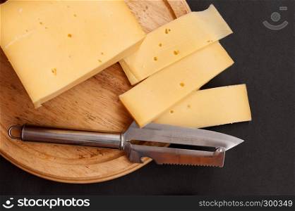 cheese on cutting board with cheese knife