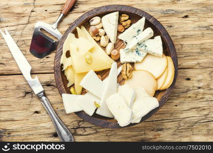 Cheese on the table.various types of cheese on old rustic wooden table. Set of sliced cheeses
