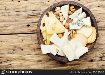 Cheese on the table.various types of cheese on old rustic wooden table. Set of sliced cheeses