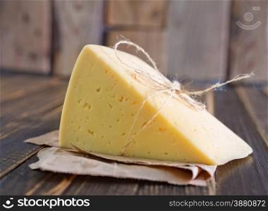cheese on the wooden board and on a table