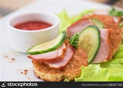 Cheese pancakes. pancakes with ham and cucumber with tomato sauce and lettuce