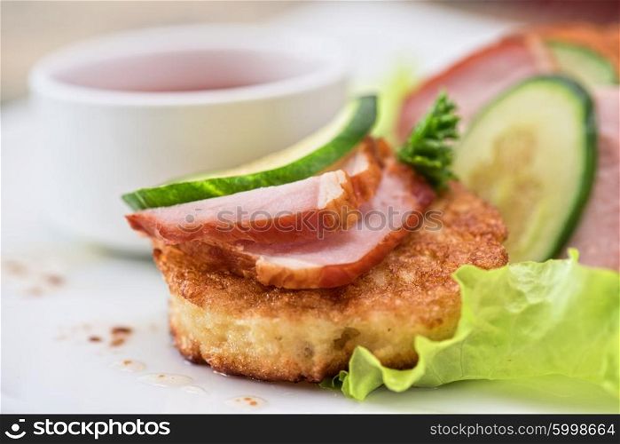 Cheese pancakes with ham. pancakes with ham and cucumber with tomato sauce and lettuce