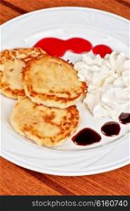 Cheese pancakes with sour cream . Cheese pancakes with sour cream and berry jam