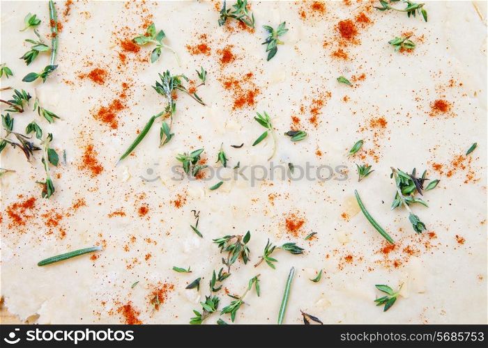 Cheese pastry dough with rolling pin on dark background