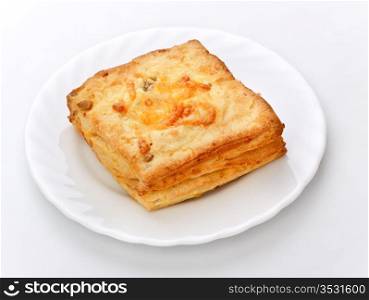cheese pie on white dish, gray background