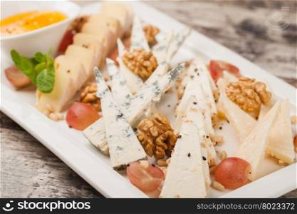 Cheese plate. cheese plate with grapes and nuts