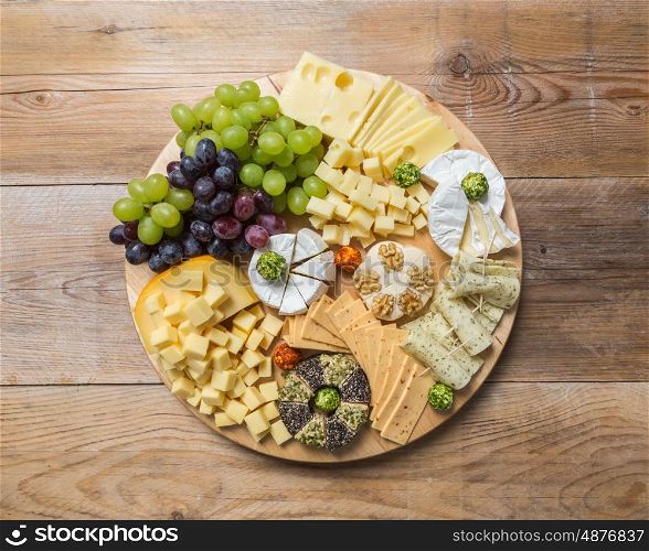 Cheese plate variation on a wooden table. Cheese plate variation on a wooden table.