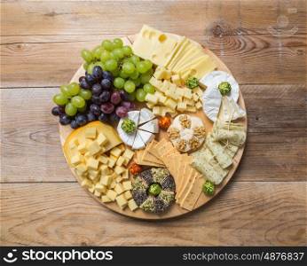 Cheese plate variation on a wooden table. Cheese plate variation on a wooden table.