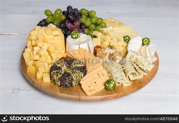 Cheese plate variation on a wooden white table. Cheese plate variation on a wooden white table.